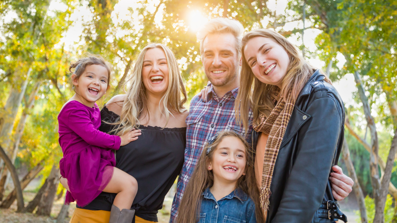 smiling adults and three daughters