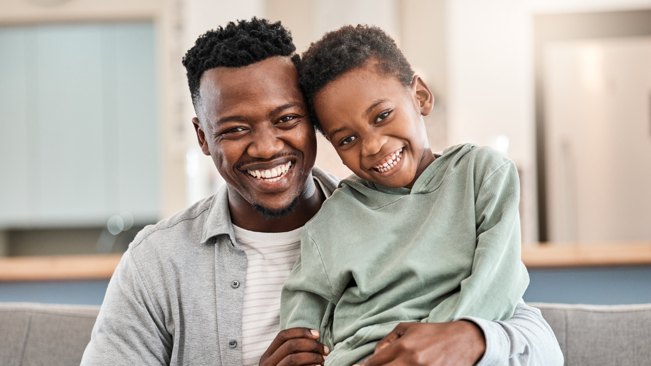 African American father and son smiling