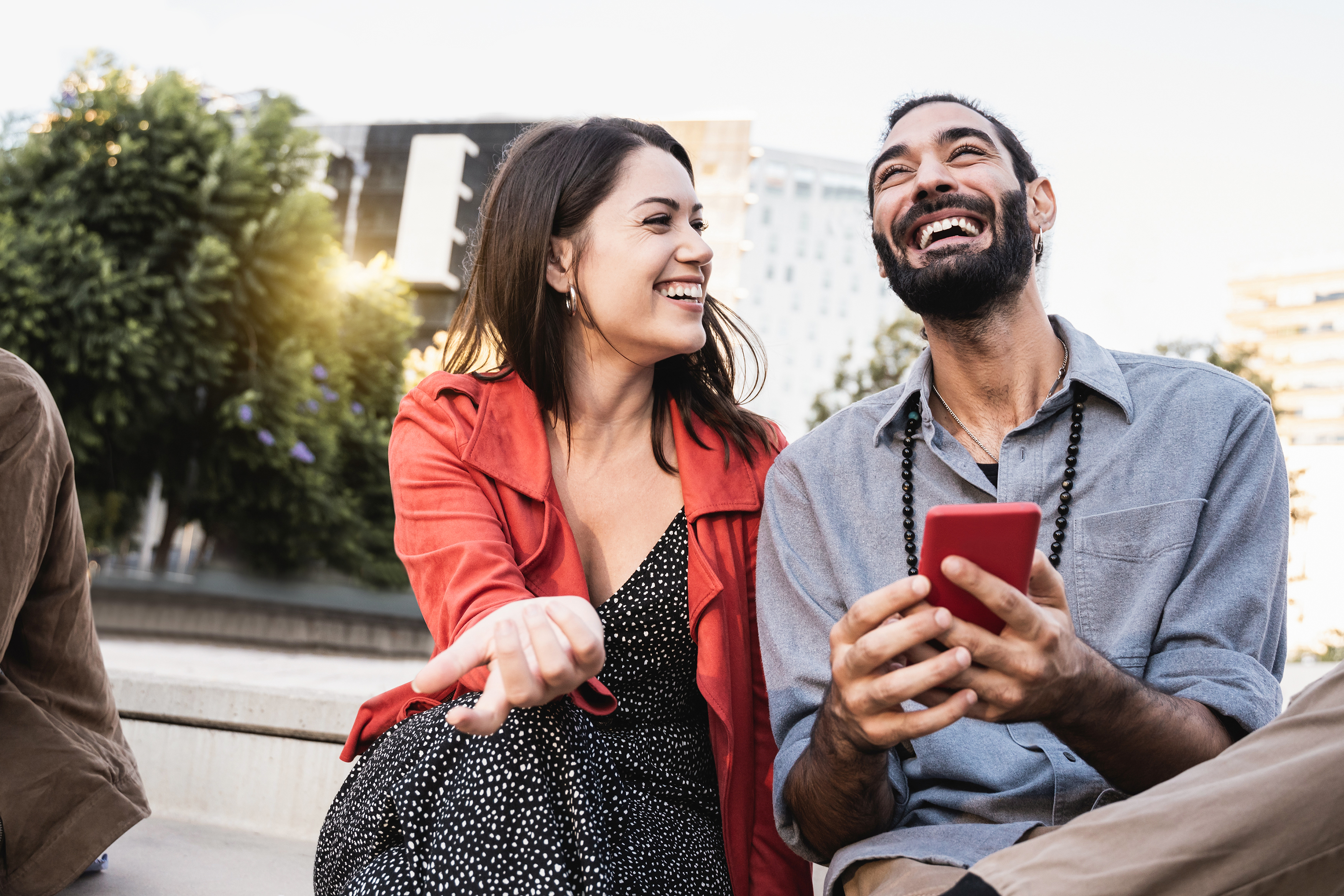 man with cell phone and woman smiling 